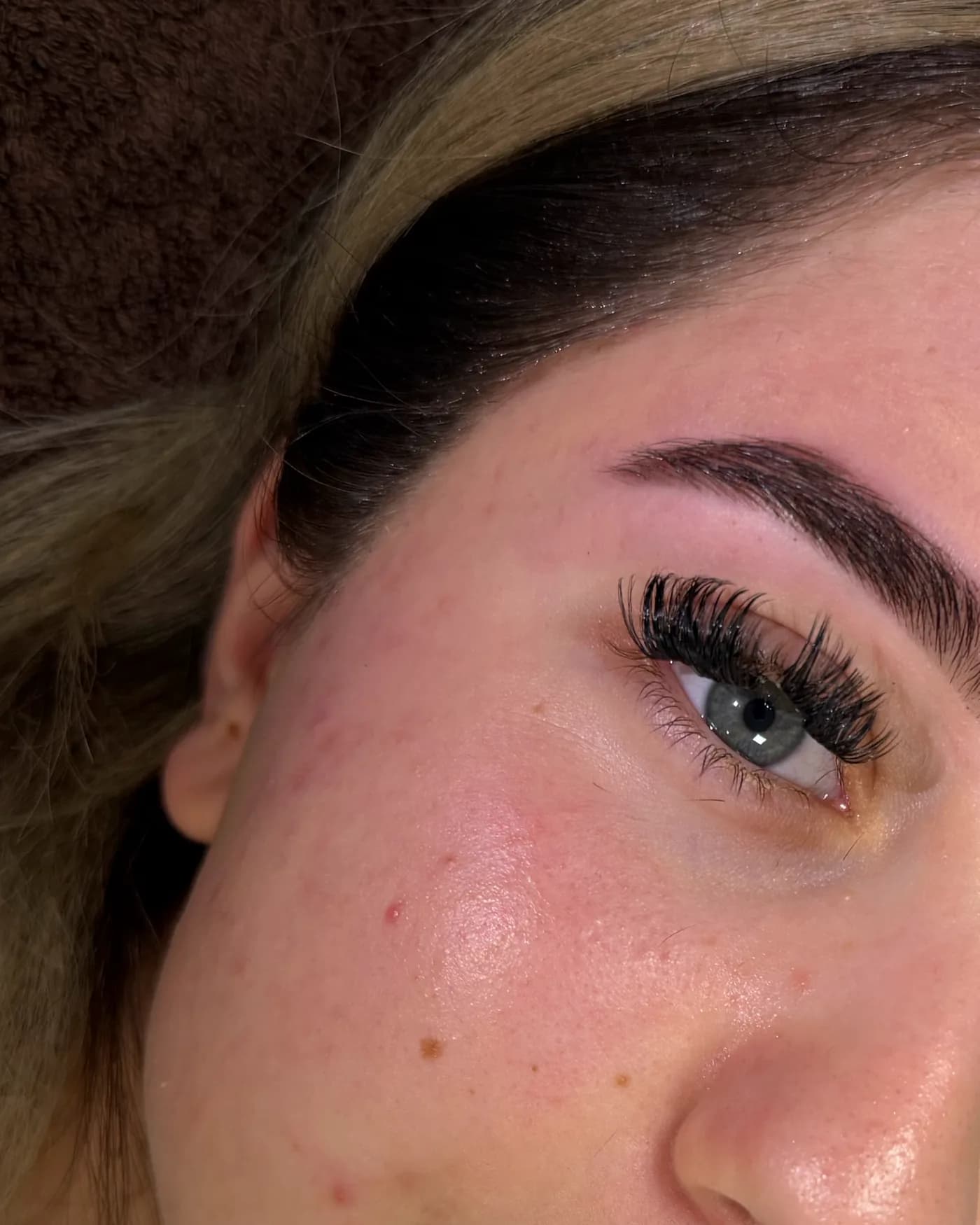 Een donkere, gevulde wenkbrauw boven een blauw oog, van dichtbij