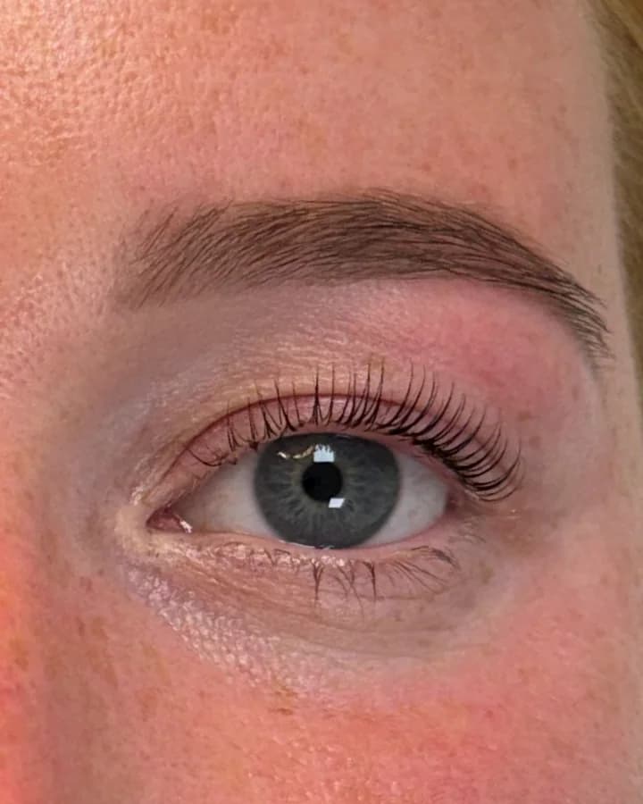 The same eye after henna brows and a Korean lash lift, with a dark, shaped brow and curled lashes
