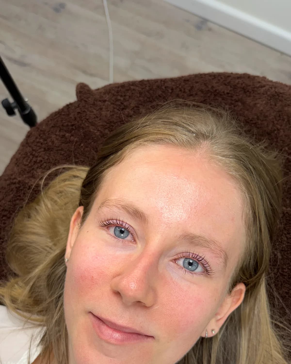 A client with blonde hair and lifted lashes, just after a lash lift